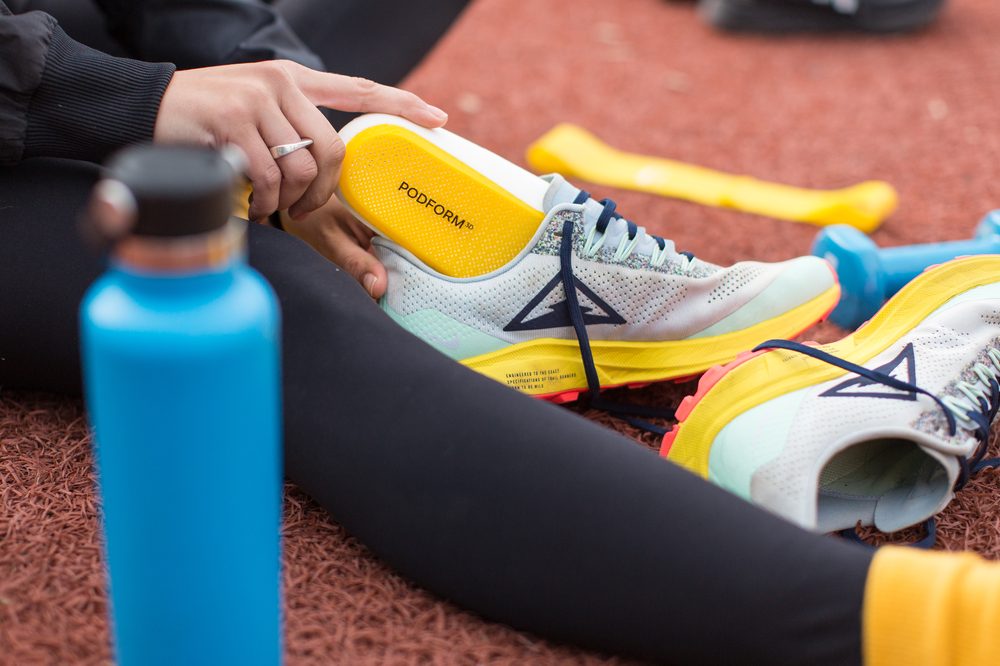 Patient walking comfortably with custom orthotics providing flat feet arch support