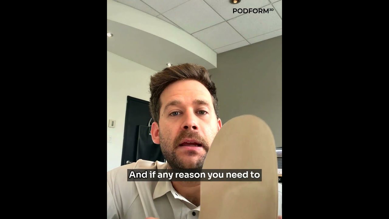 Dr. Antonin Bérubé holding a finished foot orthotic with a beige top cover