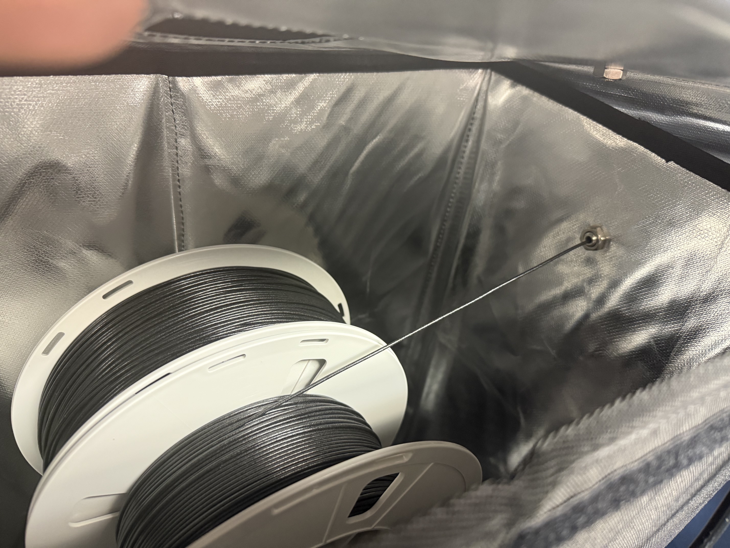 Two filament spools placed inside the dry box, creating a high-friction feed path.