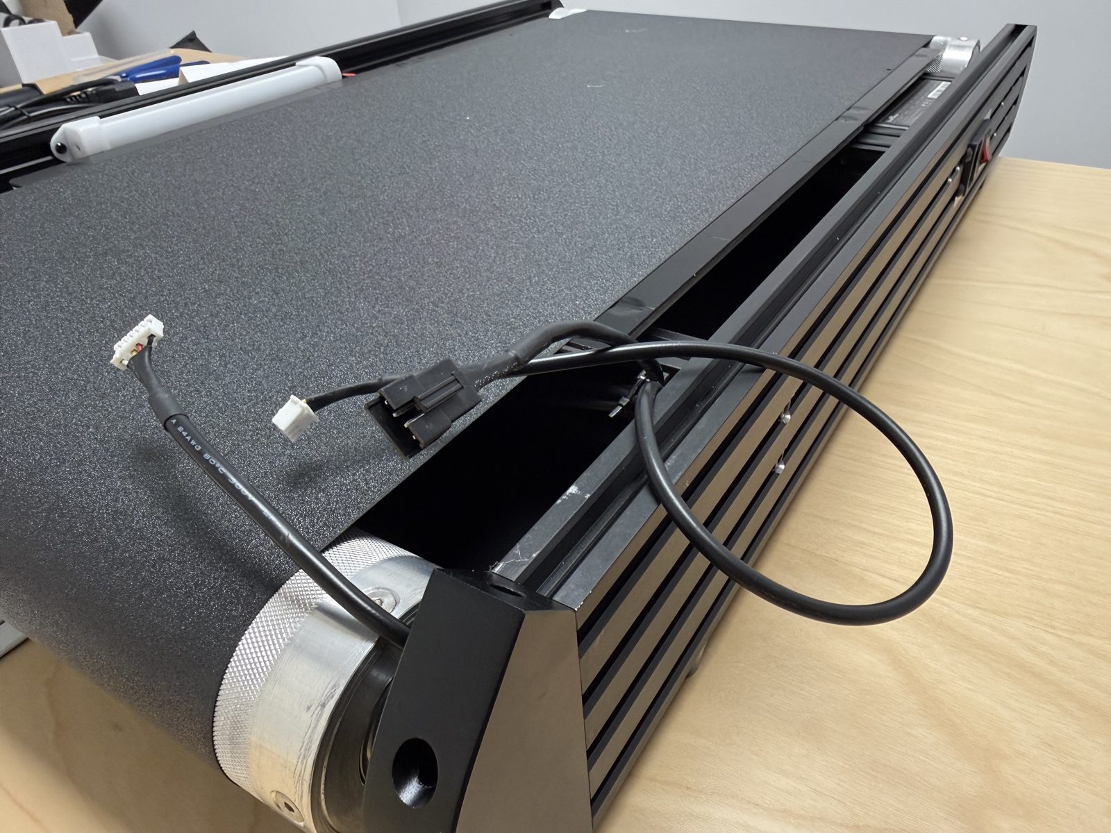 Wide underside photo showing the hidden wire bundle under the bed