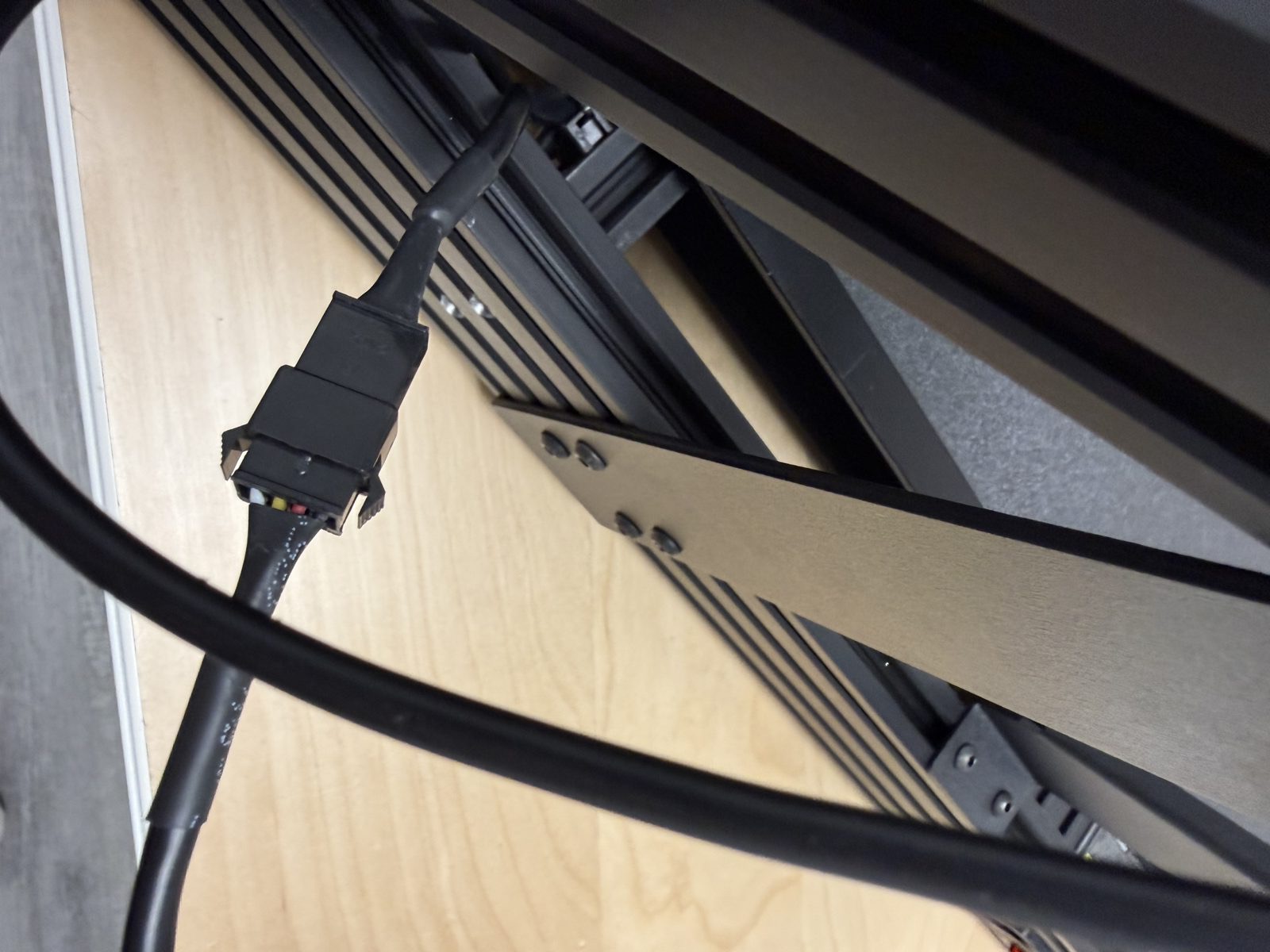 Close-up photo of the black print-head cable connection near the frame